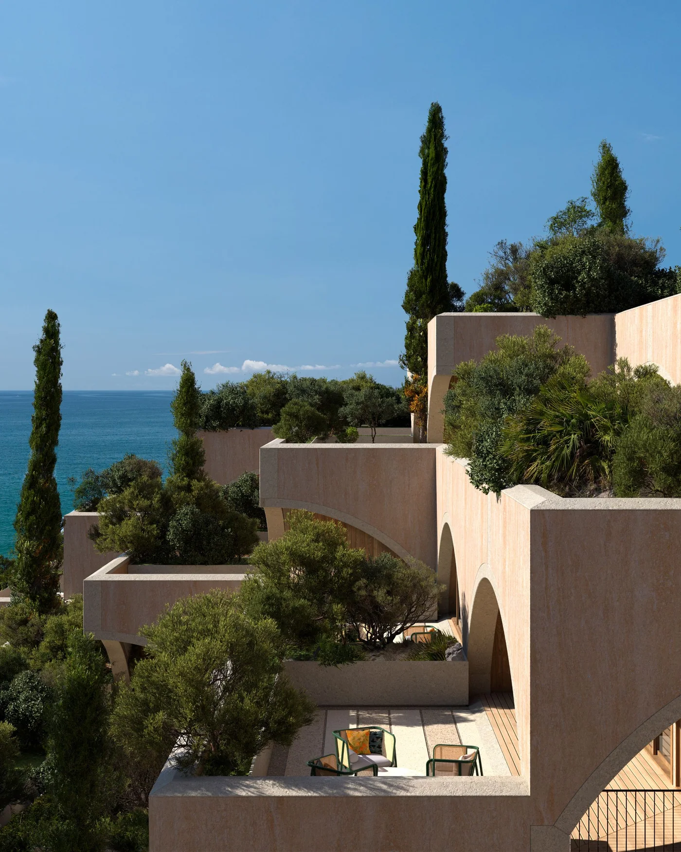 A terrace with cypresses and the sea behind
